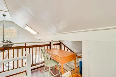 a room with a wooden table and a chair at 8 Mi to Big Boulder Mountain Cabin with Decks! in Albrightsville