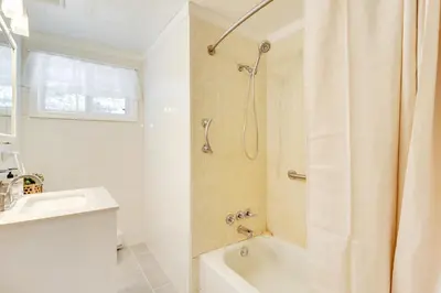 a bathroom with a shower and a sink and a tub at 8 Mi to Big Boulder Mountain Cabin with Decks! in Albrightsville