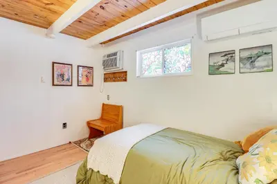a bedroom with a bed and a chair in it at 8 Mi to Big Boulder Mountain Cabin with Decks! in Albrightsville
