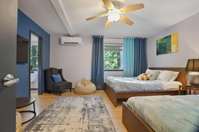 a bedroom with two beds and a ceiling fan at 5 Bedroom Cozy Retreat Lakefront in Mount Zion