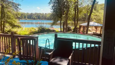 a swimming pool with a view of a lake at 5 Bedroom Cozy Retreat Lakefront in Mount Zion