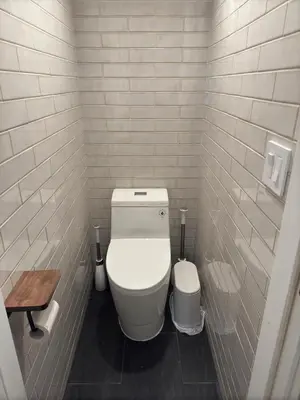 a small bathroom with a toilet and a wooden table at NEW Modern Private Entrance 2 BD Apt Minutes to NYC in Jersey City