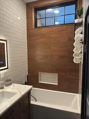 a bathroom with a tub and a sink and a window at NEW Modern Private Entrance 2 BD Apt Minutes to NYC in Jersey City