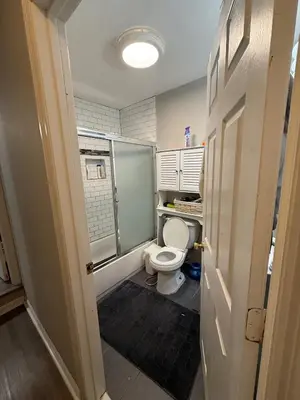 a small bathroom with a toilet and a window at Cliffwood villa - 4 Bedroom House in Cliffwood Beach