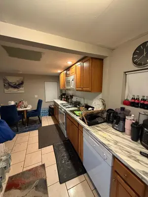 a kitchen with wooden cabinets and a counter top at Cliffwood villa - 4 Bedroom House in Cliffwood Beach