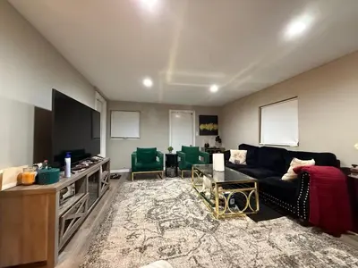 a living room with a couch and a tv at Cliffwood villa - 4 Bedroom House in Cliffwood Beach
