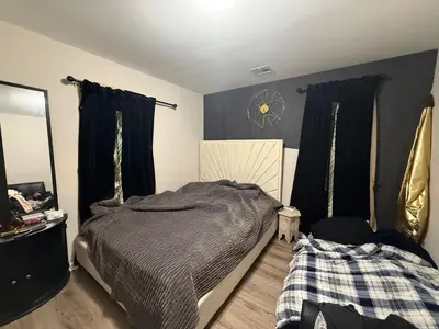 a bedroom with a bed and a clock on the wall at Cliffwood villa - 4 Bedroom House in Cliffwood Beach