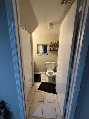 a small bathroom with a toilet in a room at Cliffwood villa - 4 Bedroom House in Cliffwood Beach