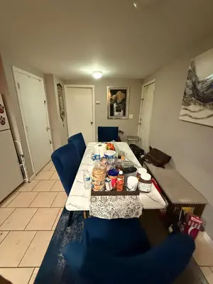 a dining table with blue chairs in a room at Cliffwood villa - 4 Bedroom House in Cliffwood Beach
