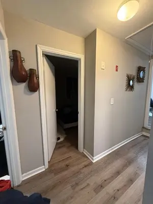 an empty living room with an open door and a room with at Cliffwood villa - 4 Bedroom House in Cliffwood Beach