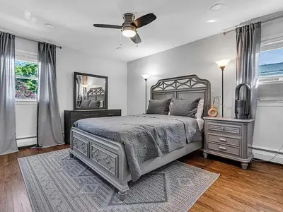 a bedroom with a bed and a ceiling fan at Suburban 3BR Stylish Oasis in Maplewood