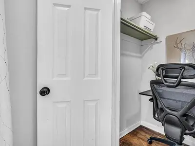 a black office chair sitting in front of a door at Suburban 3BR Stylish Oasis in Maplewood