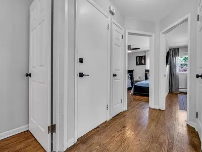 a room with white doors and a bedroom at Suburban 3BR Stylish Oasis in Maplewood