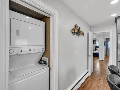 a living room with a flat screen tv on a wall at Suburban 3BR Stylish Oasis in Maplewood