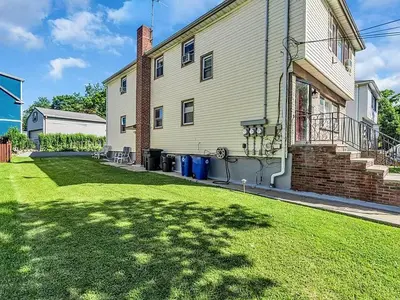 a house with a lawn in front of it at Suburban 3BR Stylish Oasis in Maplewood