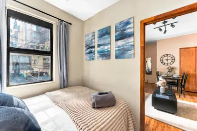 a bedroom with a bed and a window at Stylish 2 Bedroom Apartment in Chelsea in New York