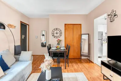 a living room with a couch and a table at Stylish 2 Bedroom Apartment in Chelsea in New York