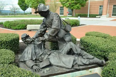 a statue of a man and a woman laying on a bench at BurgBnB Riverfront in Harrisburg