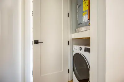 a laundry room with a washer and dryer at Blueground E Village rooftop pool gym ac NYC-1533 in New York
