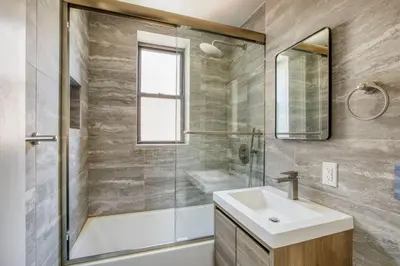 a bathroom with a sink and a shower at Blueground E Village rooftop pool gym ac NYC-1533 in New York