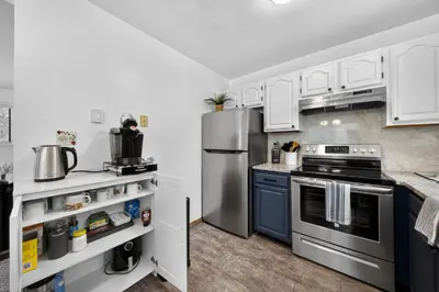 a kitchen with white cabinets and a stainless steel refrigerator at Peaceful Arrowhead Lakes Getaway Perfect for Spring and Summer Hot Tub Deck 3BR Home in Thornhurst