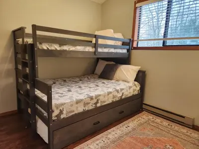 a bedroom with two bunk beds in a room at Peaceful Arrowhead Lakes Getaway Perfect for Spring and Summer Hot Tub Deck 3BR Home in Thornhurst