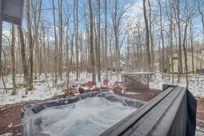 a hot tub in the snow in a yard at Peaceful Arrowhead Lakes Getaway Perfect for Spring and Summer Hot Tub Deck 3BR Home in Thornhurst