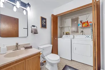 a bathroom with a white toilet and a sink at Peaceful Arrowhead Lakes Getaway Perfect for Spring and Summer Hot Tub Deck 3BR Home in Thornhurst