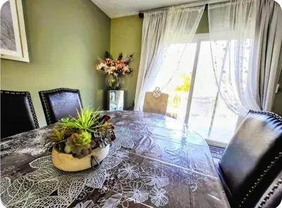 a dining room with a table with a potted plant on it at Cozy House in Long Pond 3 bedrooms 10 people in Long Pond