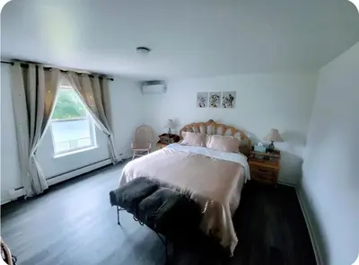 a bedroom with a large bed and a window at Cozy House in Long Pond 3 bedrooms 10 people in Long Pond
