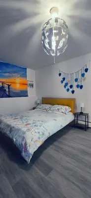 a bedroom with a bed and a chandelier at Cozy House in Long Pond 3 bedrooms 10 people in Long Pond