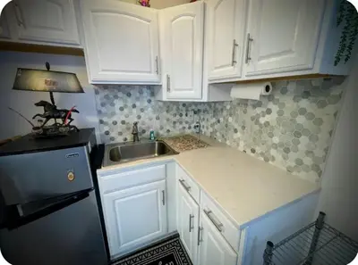 a kitchen with white cabinets and a sink and a refrigerator at Cozy House in Long Pond 3 bedrooms 10 people in Long Pond