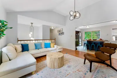 a living room with a white couch and a table at Gorgeous 4BR Home with Hot Tub,Pool& Sauna in East Stroudsburg