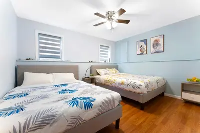 a bedroom with two beds and a ceiling fan at Gorgeous 4BR Home with Hot Tub,Pool& Sauna in East Stroudsburg