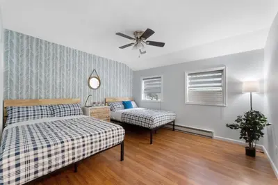 a bedroom with two beds and a ceiling fan at Gorgeous 4BR Home with Hot Tub,Pool& Sauna in East Stroudsburg