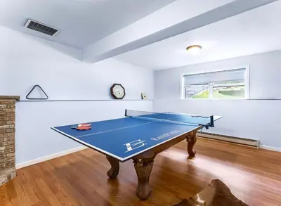 a room with a ping pong table in it at Gorgeous 4BR Home with Hot Tub,Pool& Sauna in East Stroudsburg