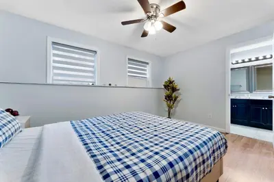 a bedroom with a bed and a ceiling fan at Gorgeous 4BR Home with Hot Tub,Pool& Sauna in East Stroudsburg