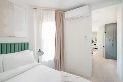 a bedroom with a white bed and a green headboard at 48-3FE 2BR Prime Midtown West in New York