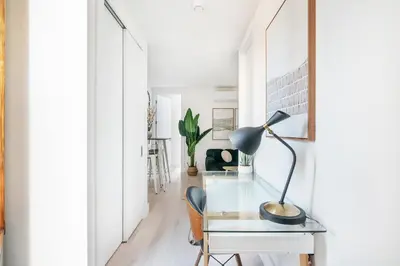 a home office with a glass desk and a lamp at 48-3FE 2BR Prime Midtown West in New York