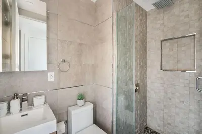 a bathroom with a shower and a toilet and a sink at 48-3FE 2BR Prime Midtown West in New York