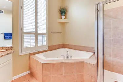 a bathroom with a bath tub and a shower at Boulder Lake Access Townhome with Deck! in Lake Harmony