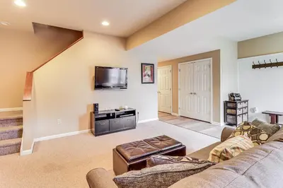 a living room with a couch and a tv at Boulder Lake Access Townhome with Deck! in Lake Harmony