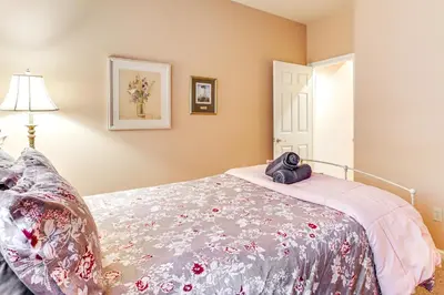 a bedroom with a bed with a blanket on it at Boulder Lake Access Townhome with Deck! in Lake Harmony