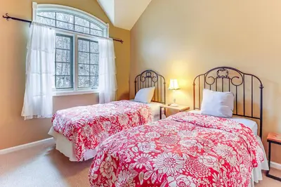 a bedroom with two beds and a window at Boulder Lake Access Townhome with Deck! in Lake Harmony