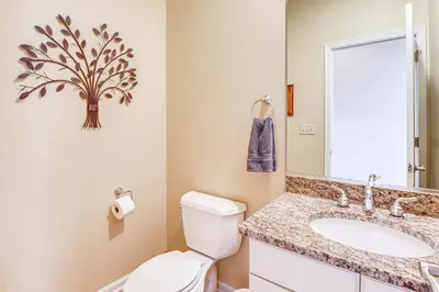 a bathroom with a toilet and a sink at Boulder Lake Access Townhome with Deck! in Lake Harmony
