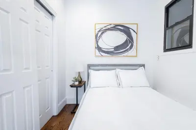 a white bedroom with a bed and a window at 69-5C Festive Comfort Brand New 1BR Lower East Side Christmas Ready in New York