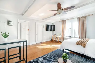 a bedroom with a bed and a ceiling fan at 73-1120 New Studio UWS Doorman Gym in New York