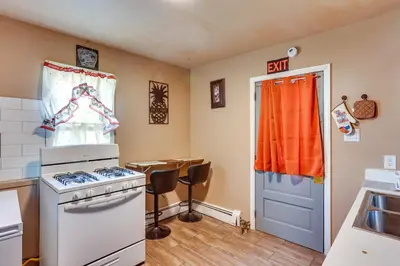 a kitchen with a stove and a table in it at HBG Apt about 3 Mi to Downtown and River! in Harrisburg