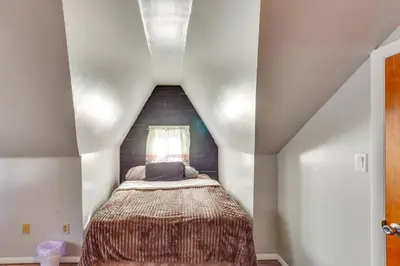 a small bedroom with a bed in a attic at HBG Apt about 3 Mi to Downtown and River! in Harrisburg