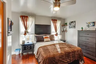 a bedroom with a bed and a dresser and windows at HBG Apt about 3 Mi to Downtown and River! in Harrisburg